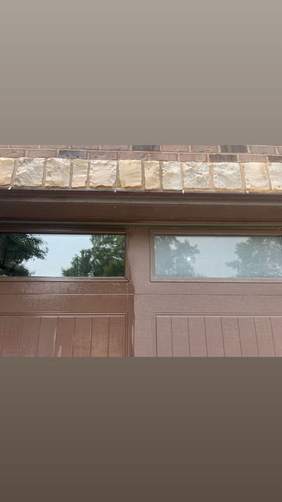 Garage door with a cleaned half next to an unwashed half