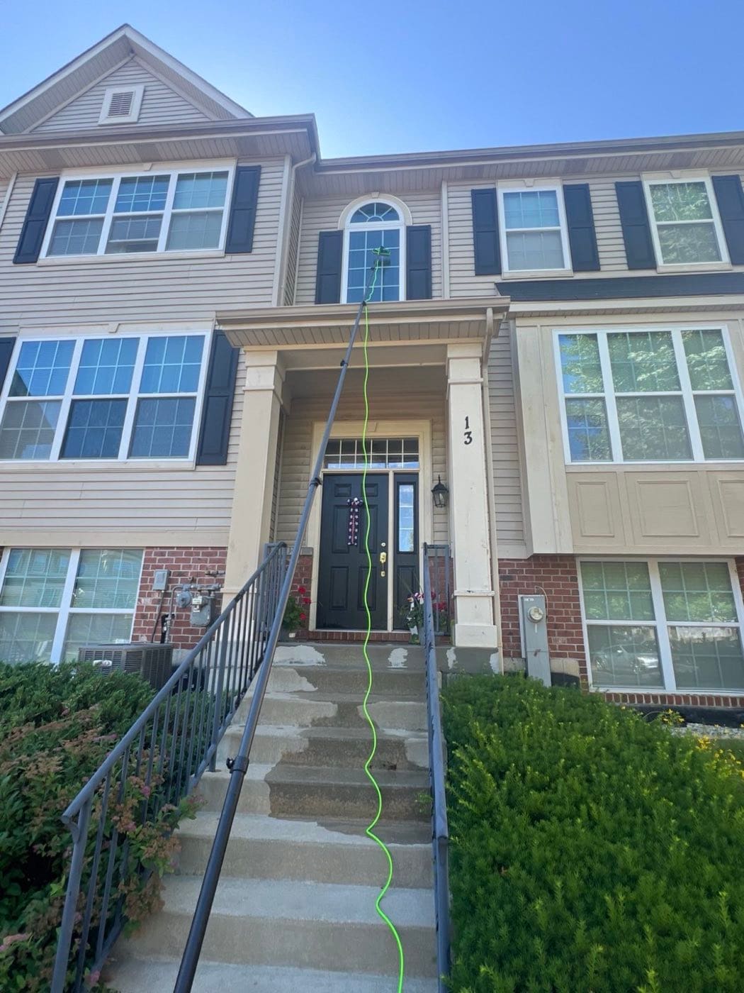 Water-fed pole cleaning an upper window of a Chicago home